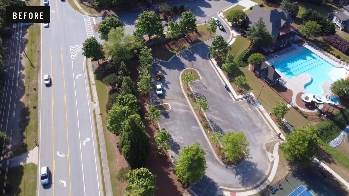 Before: aerial view of a residential community amenity lot with grey, sun-bleached pavement and faded stall lines.