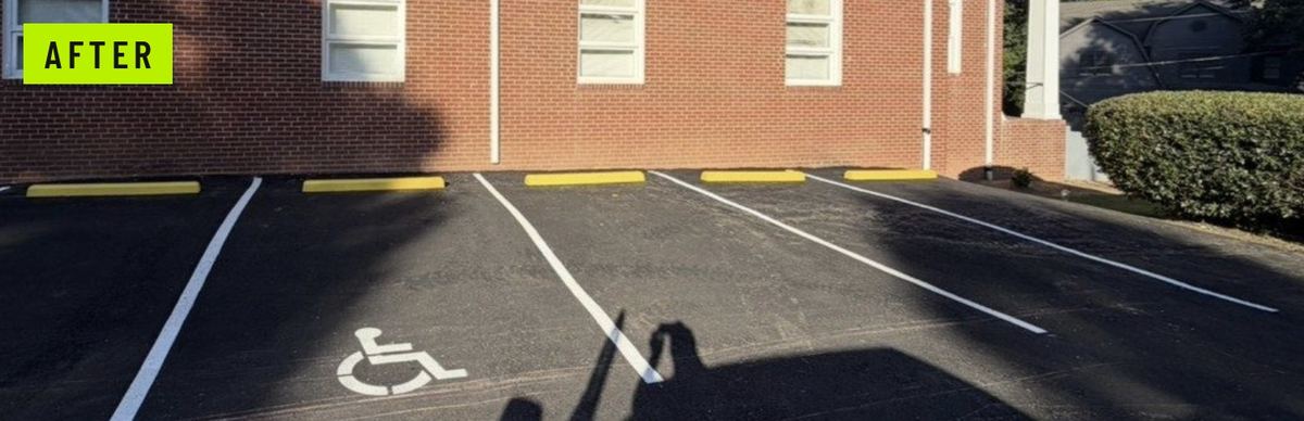 After: the same drive resurfaced with an accessible stall, access aisle, painted wheelchair symbol, and yellow wheel stops.